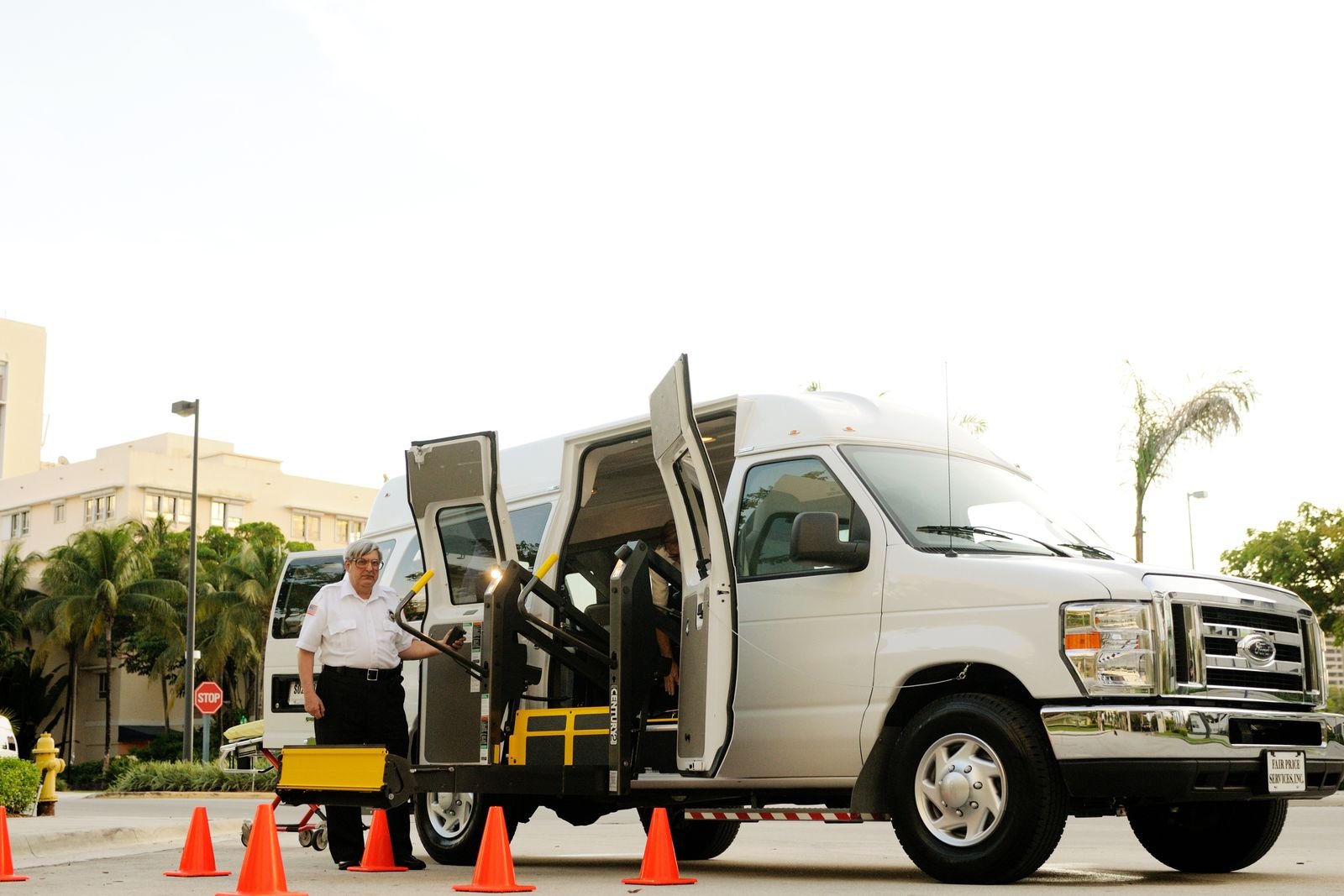 Driver beside a wheelchair accessible transport van
